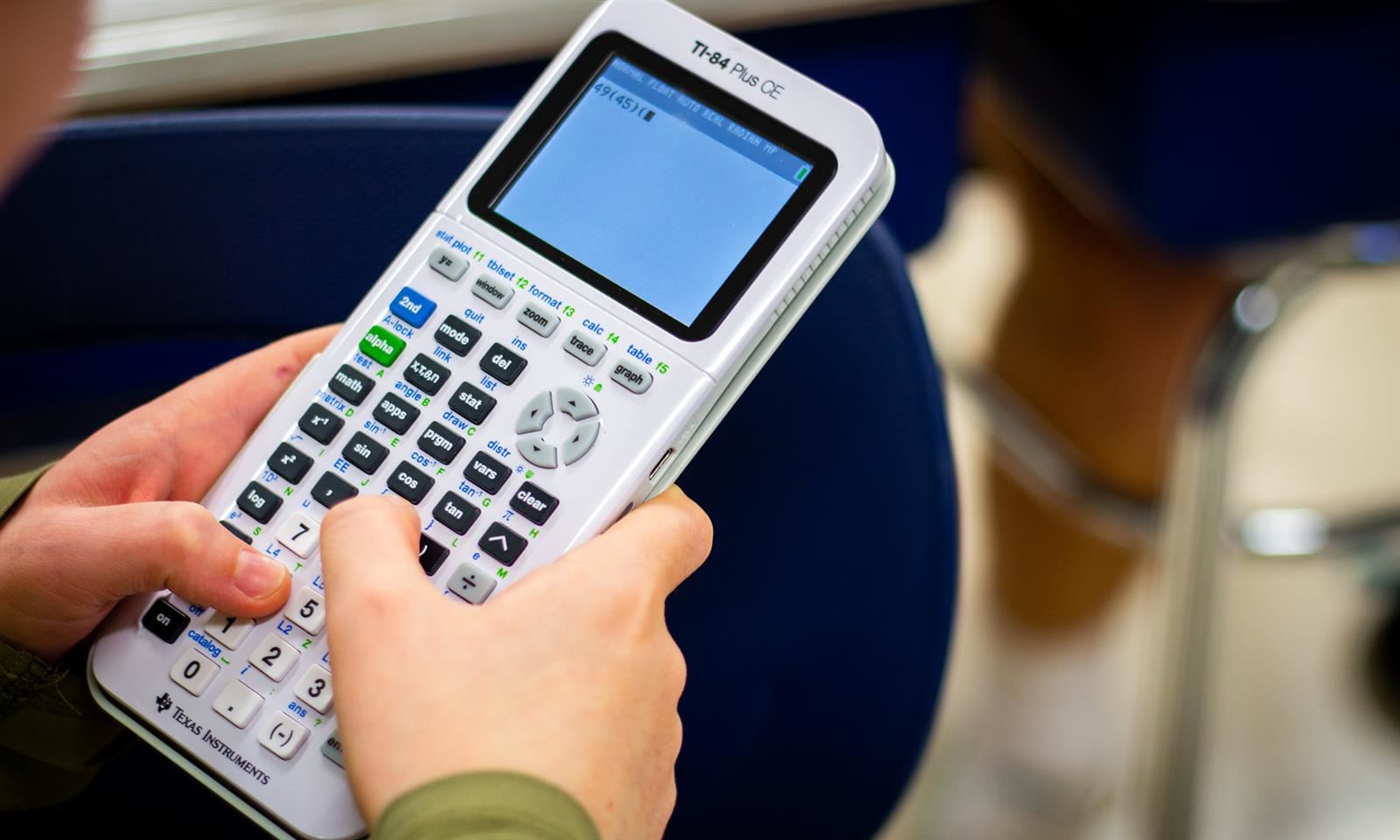 Hands holding a calculator